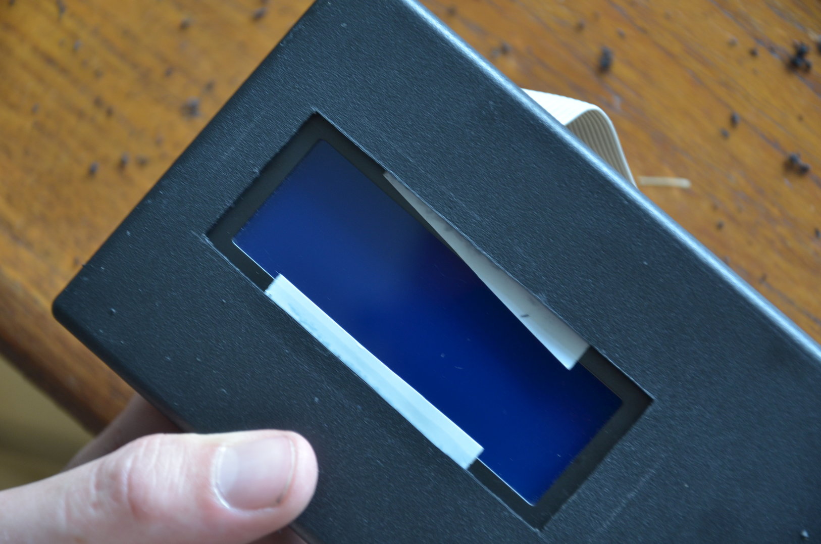 Double adhesive tape was used to hold the display in place while marking where to drill the holes