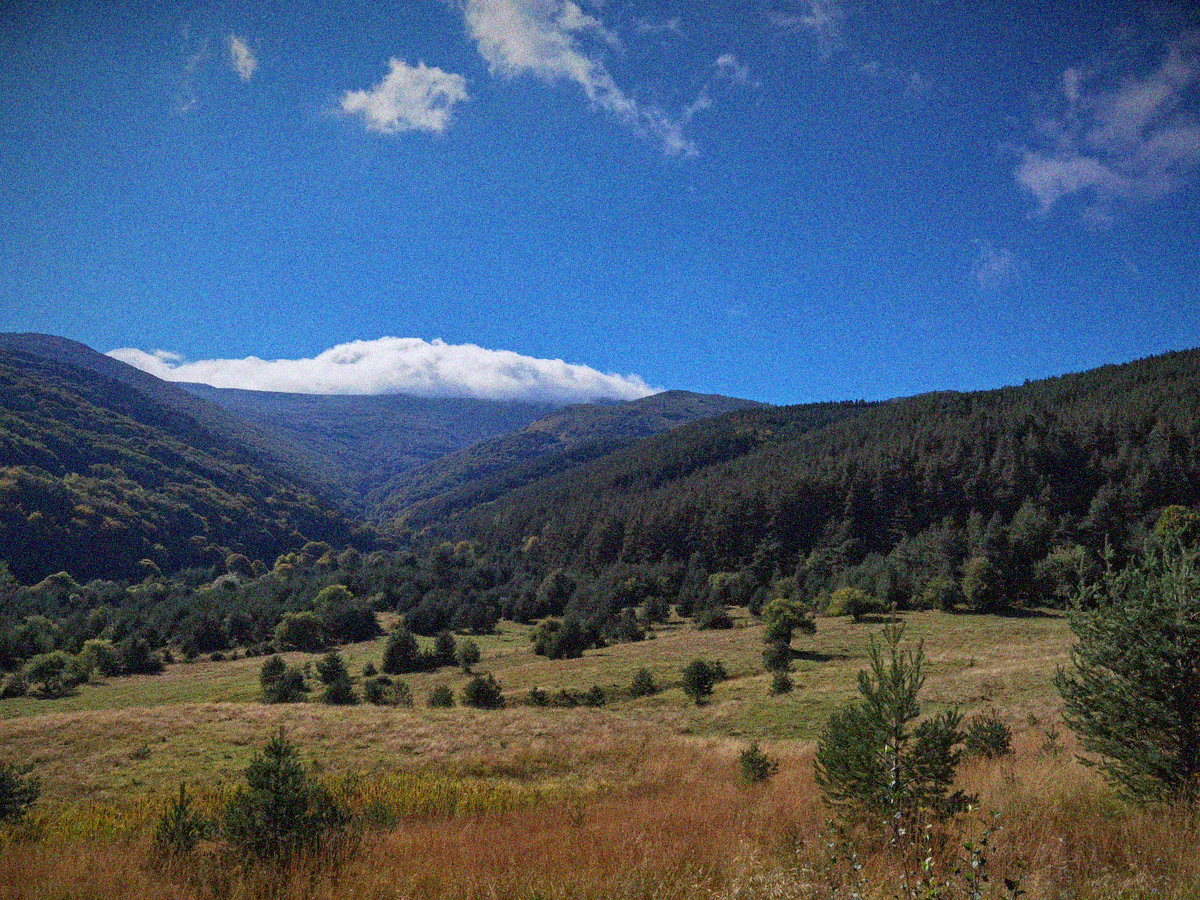 Mountains and sky landscape photo with film grain